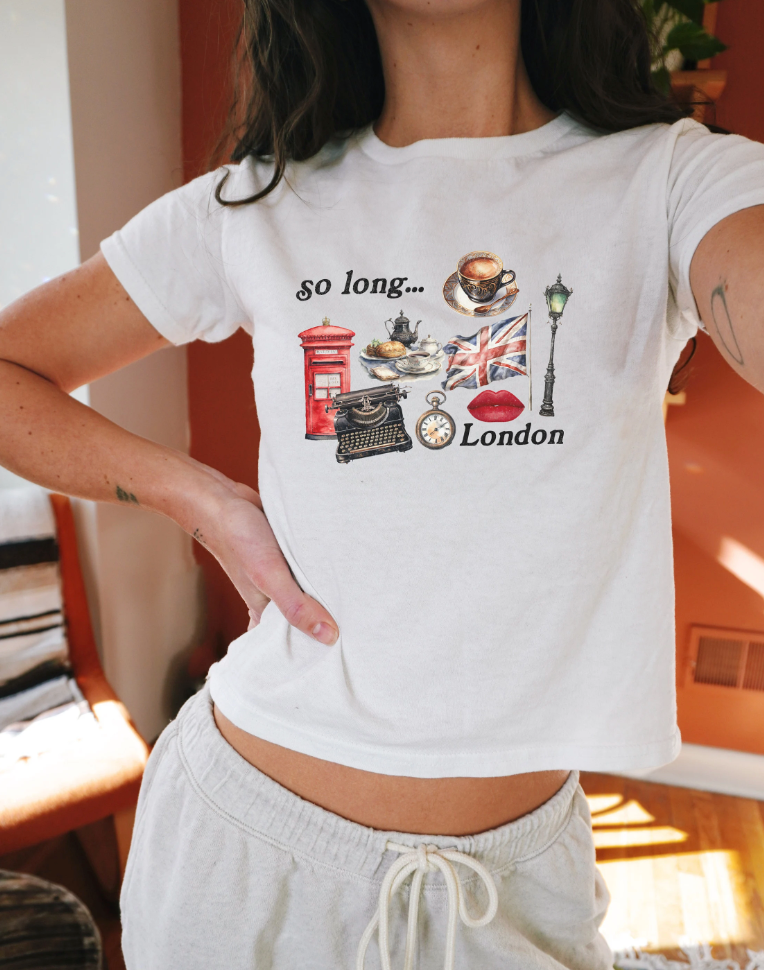 Model wearing So Long London Womens Graphic Baby Tee. Tortured Poets era graphic t shirt. Fitted Retro Graphic TTPD Top for women