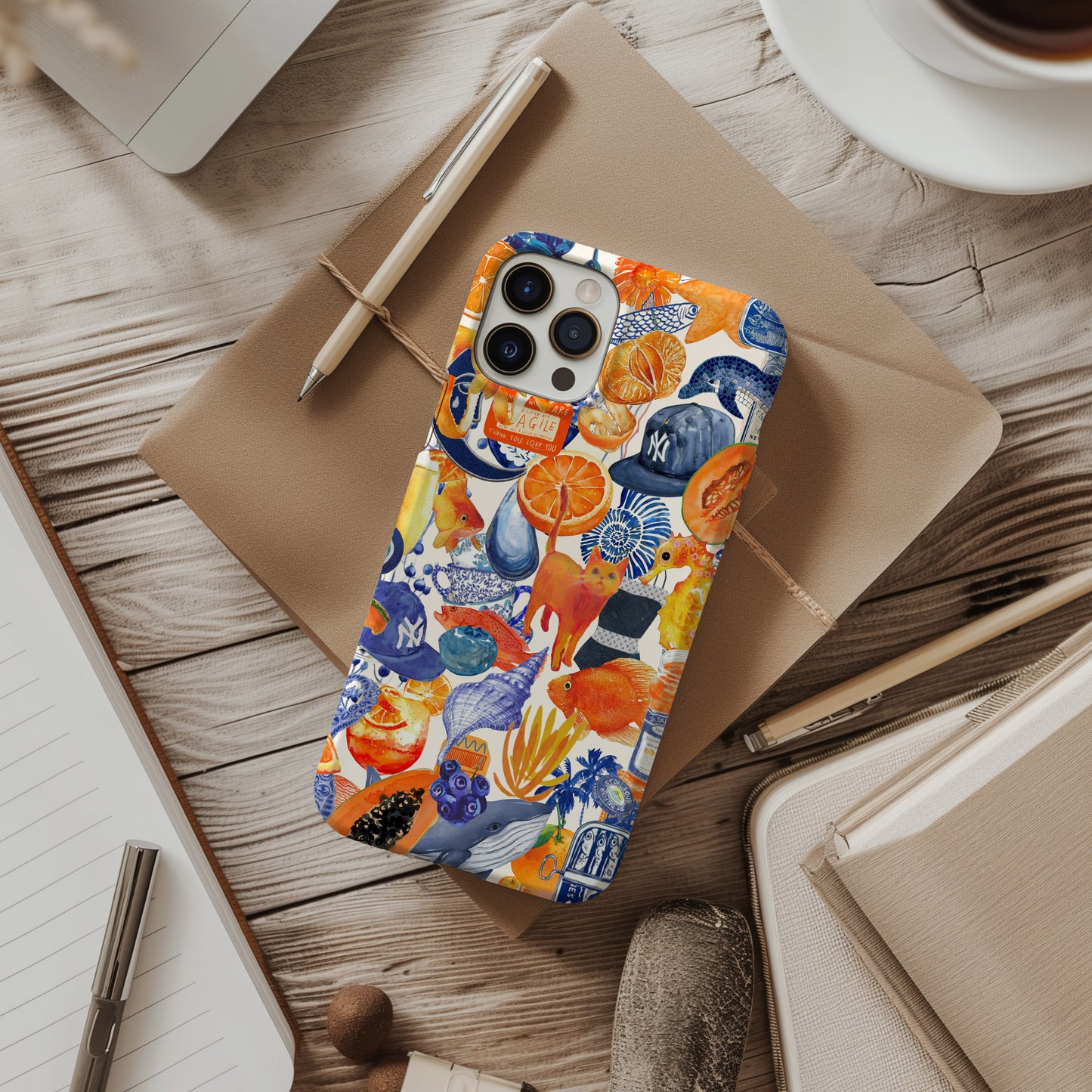 desk view of Blue and Orange Watercolor Collage Phone Case. Maximalist scrapbook style phone case for iPhone and Samsung Galaxy. Summer Phone Case by Artscape Market