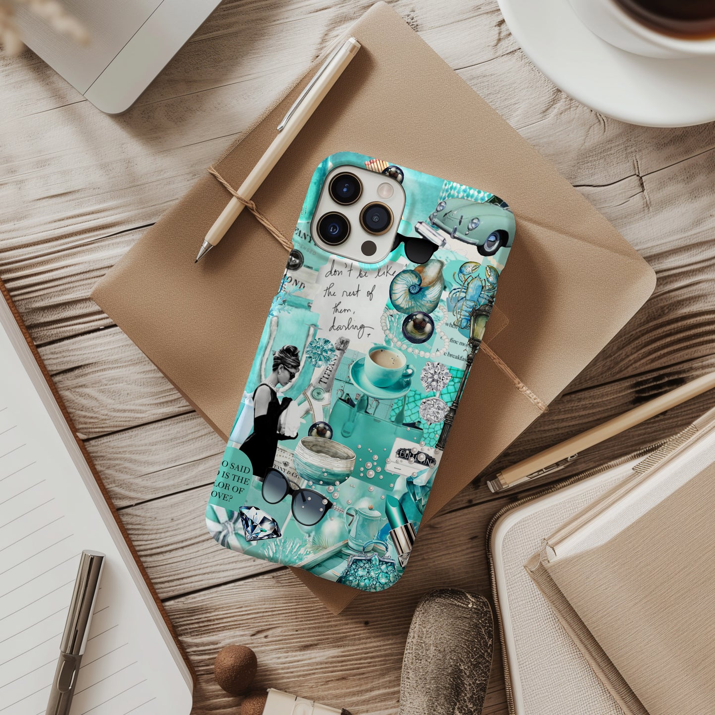 Desk view of Tiffany Blue Collage Phone Case. Breakfast at Tiffany's iconic phone case by Artscape Market